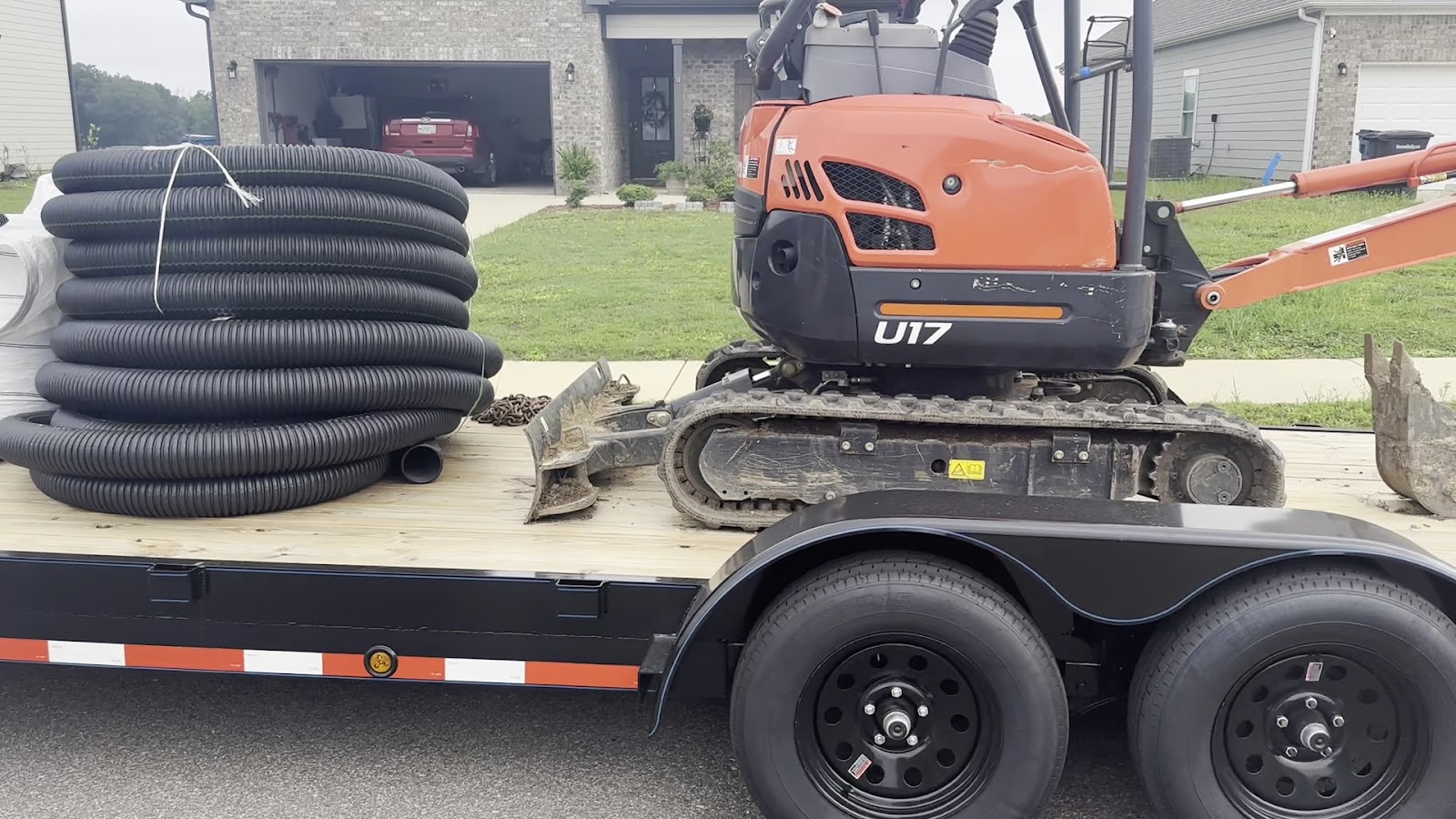 Equipment staged for a drainage and hardscape job