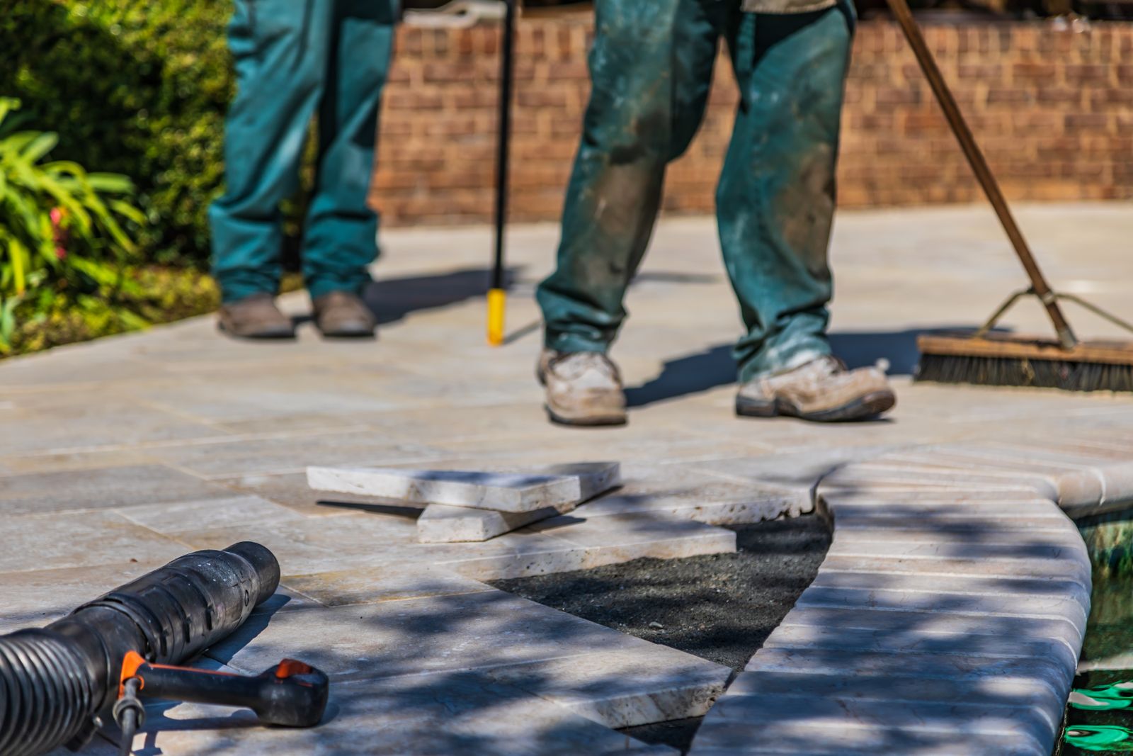 Crew installing a paver patio