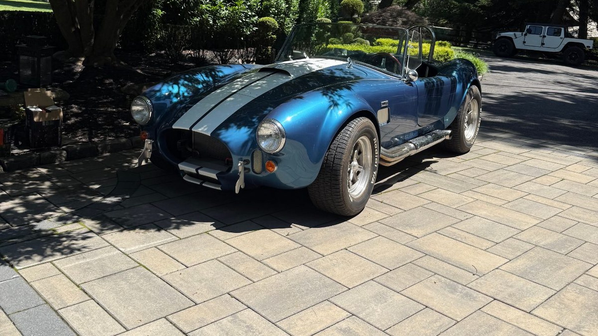 Freshly detailed blue Shelby Cobra in a Mercer County driveway