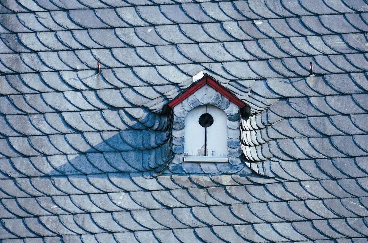 A finished slate roof with a dormer
