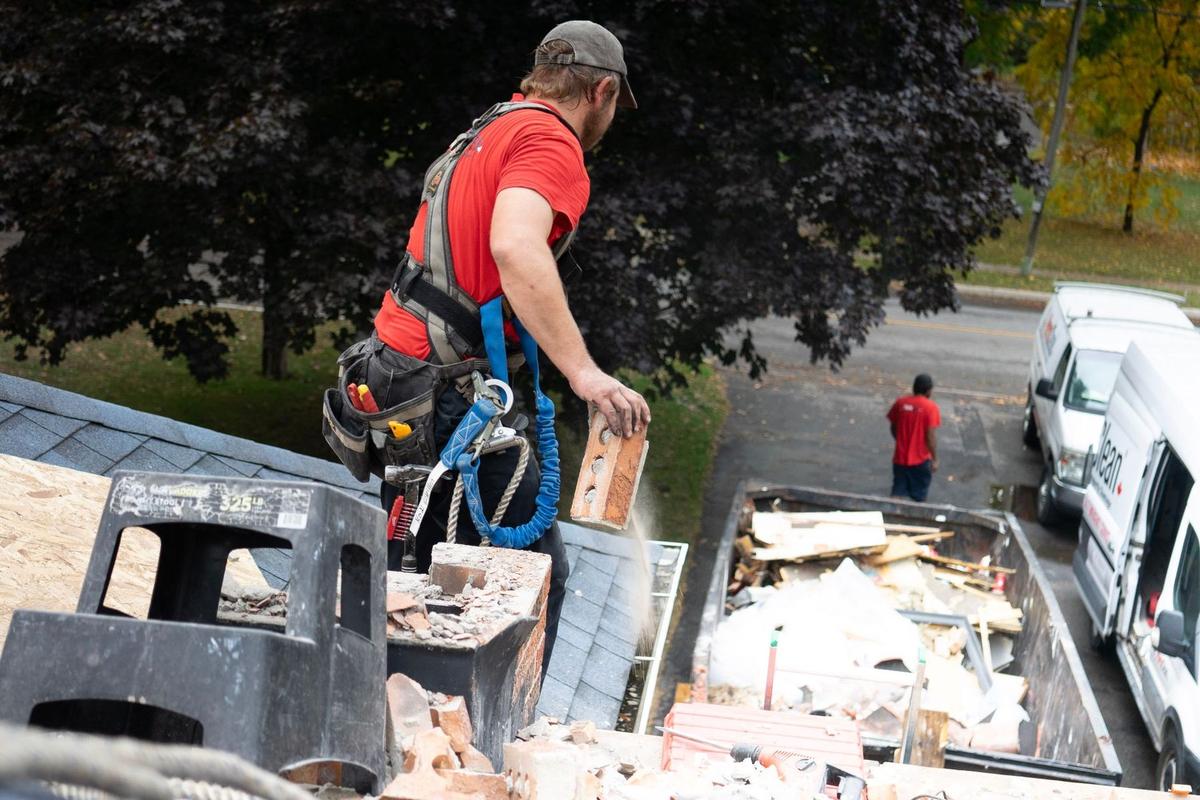 Roofer removing old roofing material