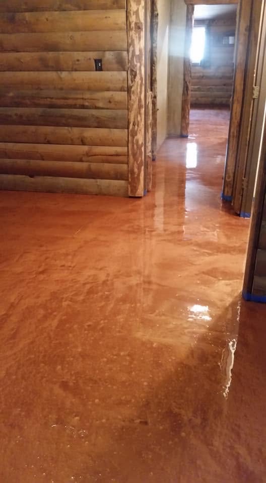 Copper stained concrete interior floor by Caliber