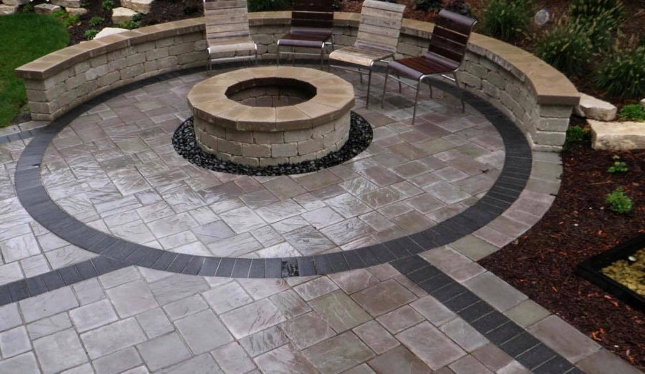 Stone paver patio with fire pit built by DeLorenzo Landscaping
