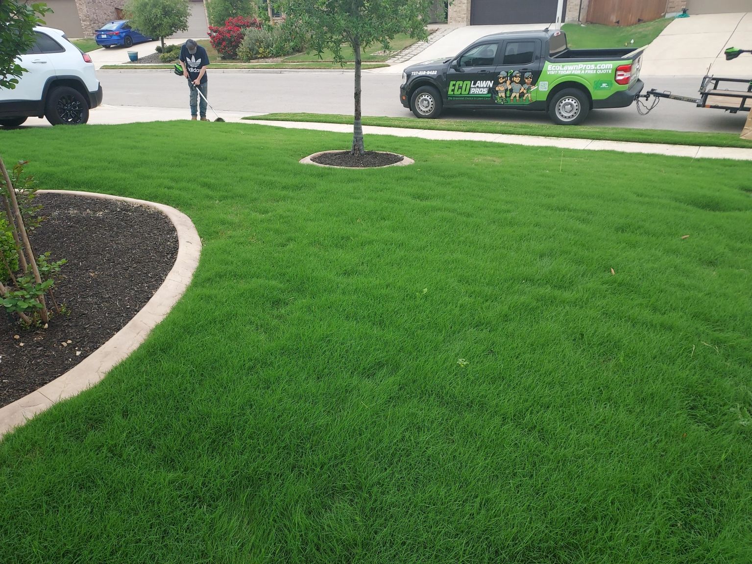 Crew mowing and maintaining a healthy green lawn