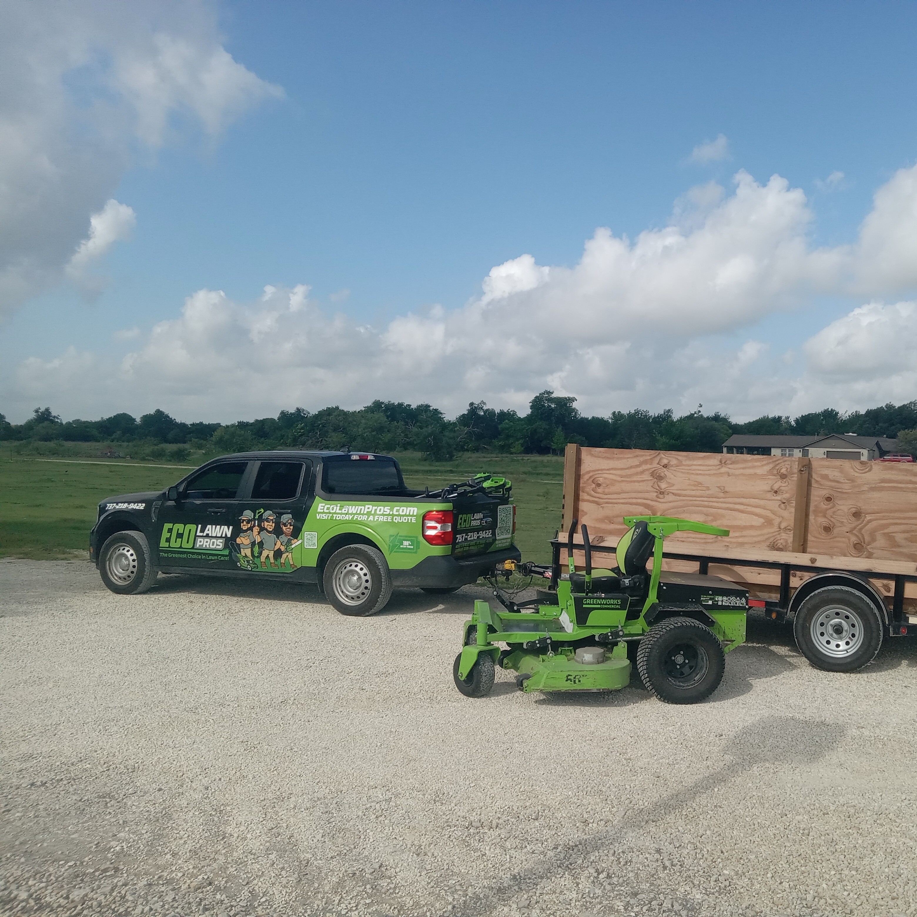Eco Lawn Pros branded truck with battery-powered Greenworks commercial mower and trailer