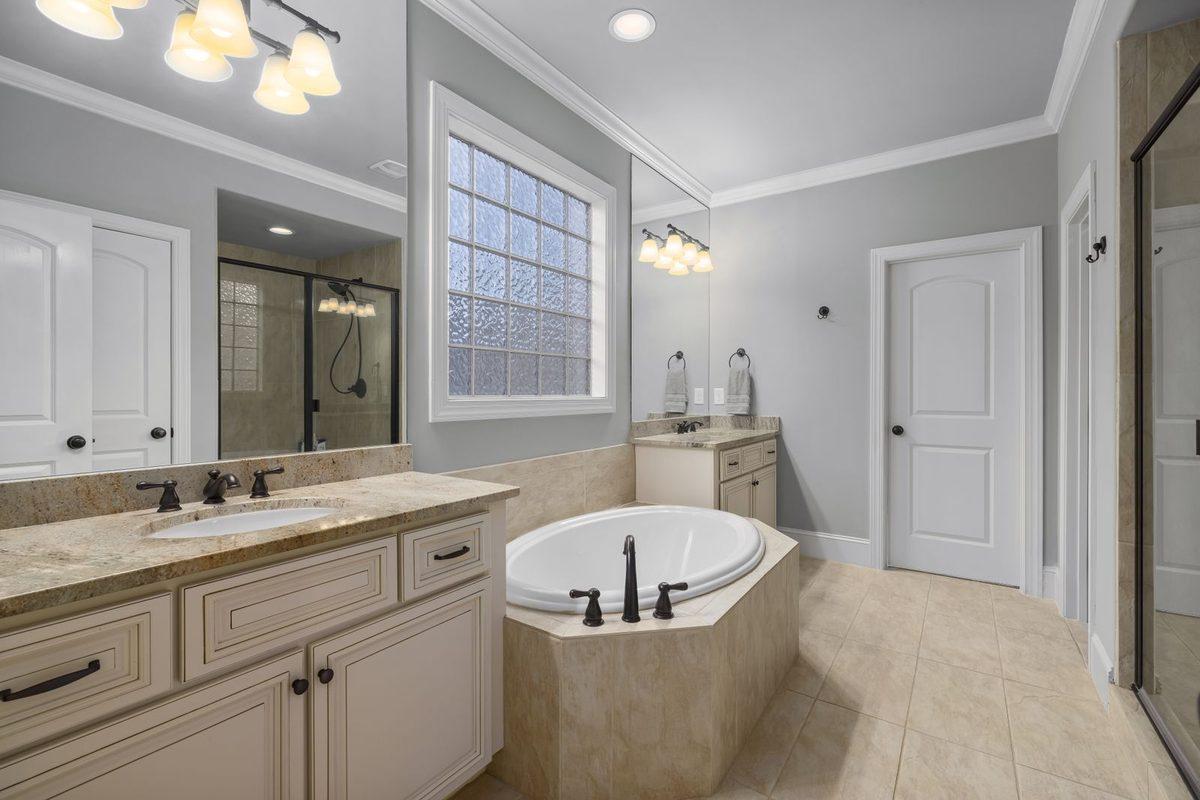 Remodeled bathroom with a wood vanity and walk-in shower