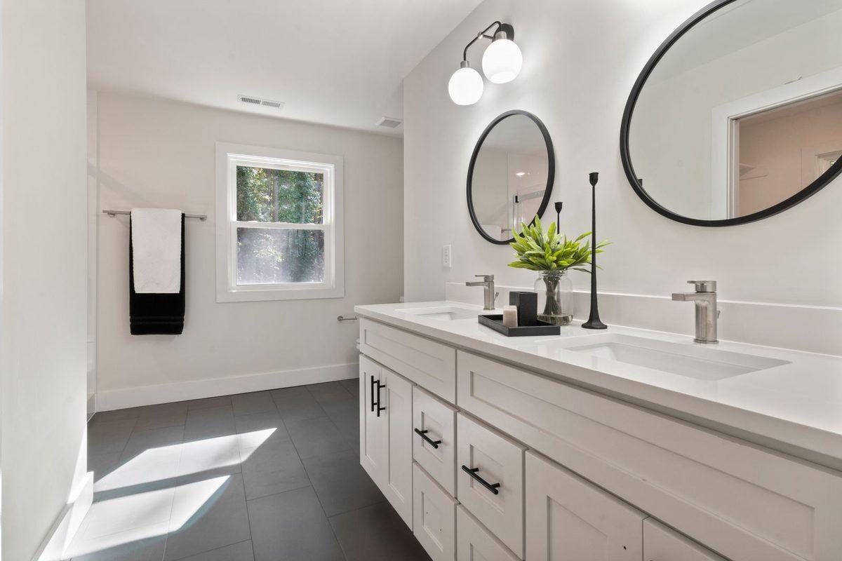 Bathroom vanity with a quartz top and brass faucet