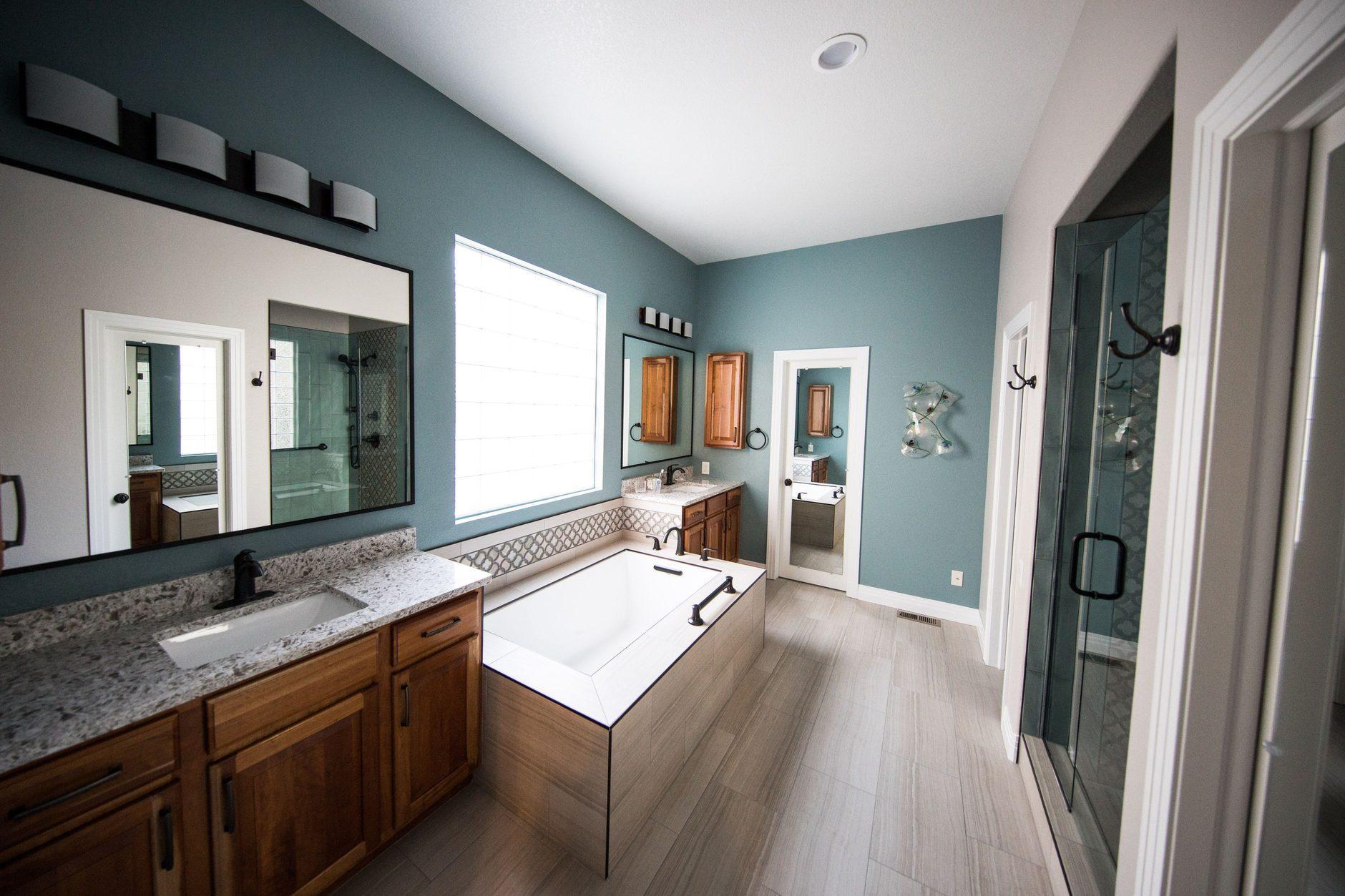 Freshly remodeled bathroom with a tiled walk-in shower and a wood vanity