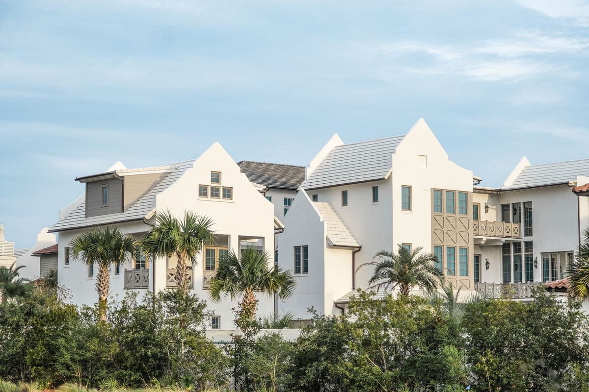 White homes with palm trees in a tropical neighborhood