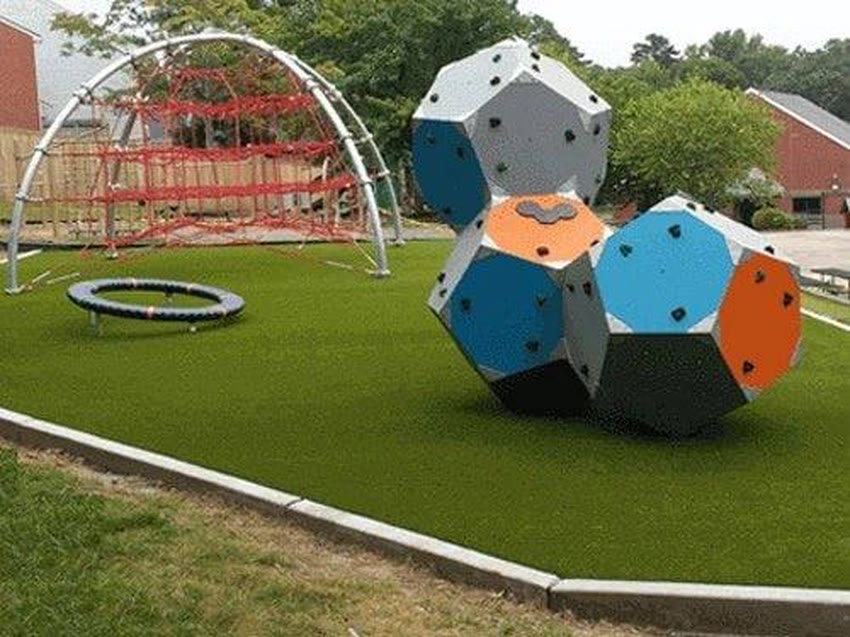 Artificial turf around climbing play equipment