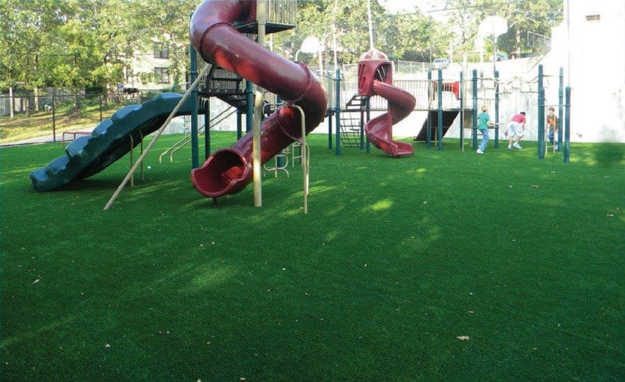 Artificial turf around a playground slide