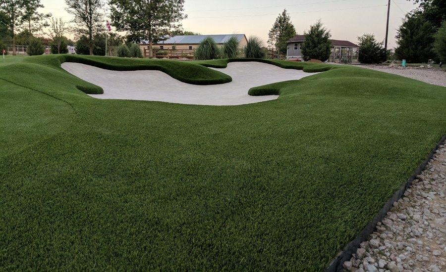 Artificial putting green with a sand bunker