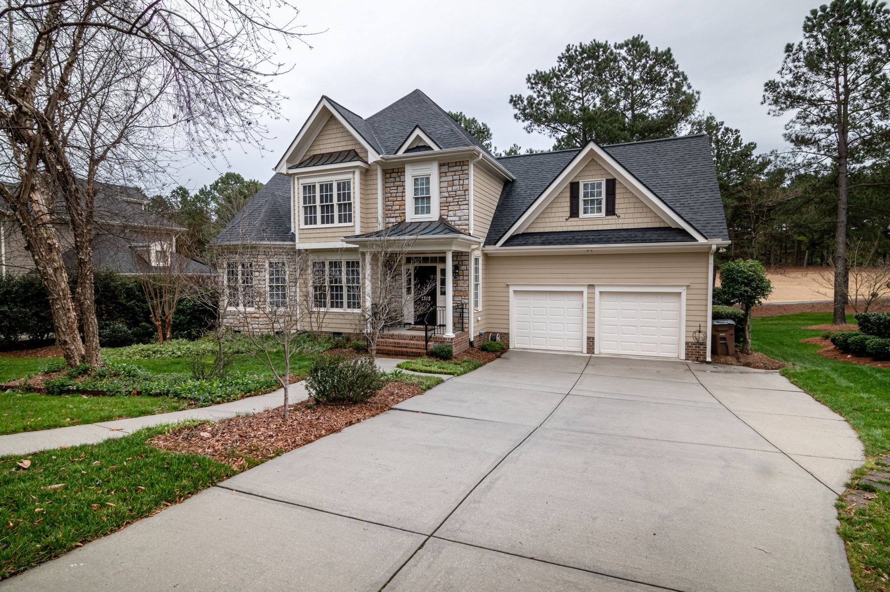 Home with a large concrete driveway