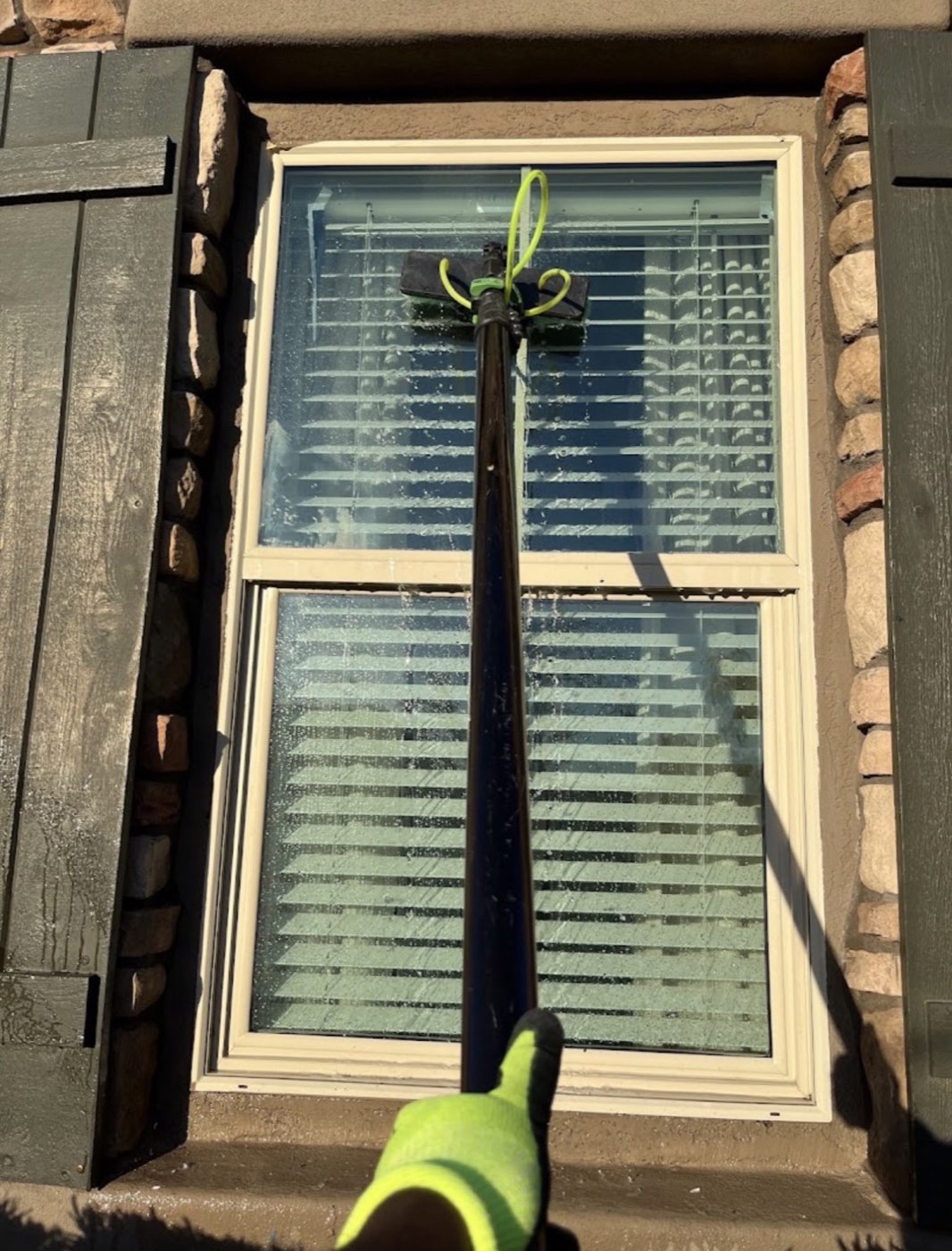 Residential window cleaning technician arriving on-site
