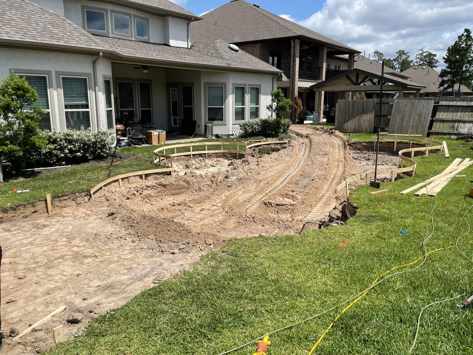 Pool layout staked and formed in a backyard