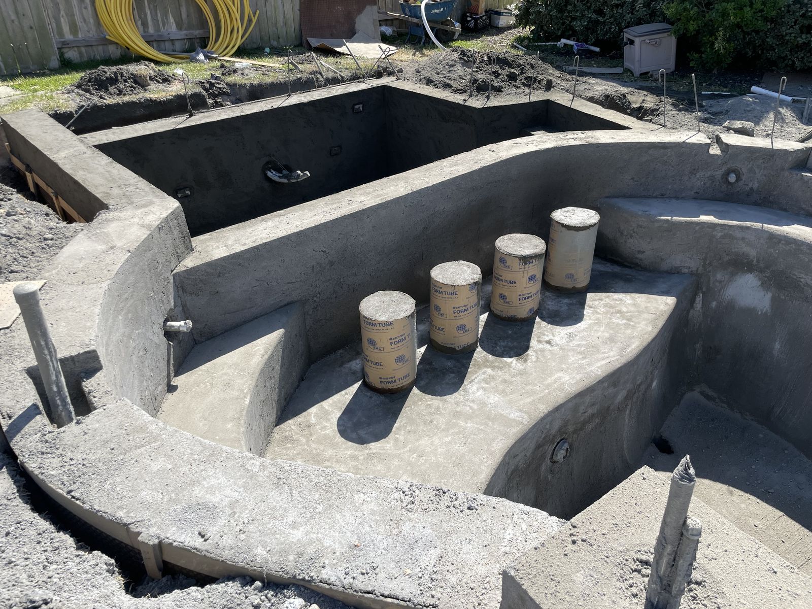Swim-up bar stools formed in the gunite shell