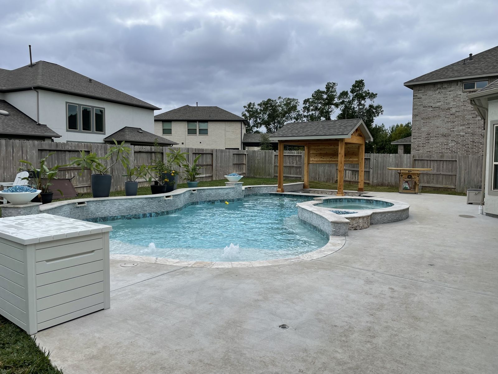 Finished pool and spa with bubblers on an overcast day