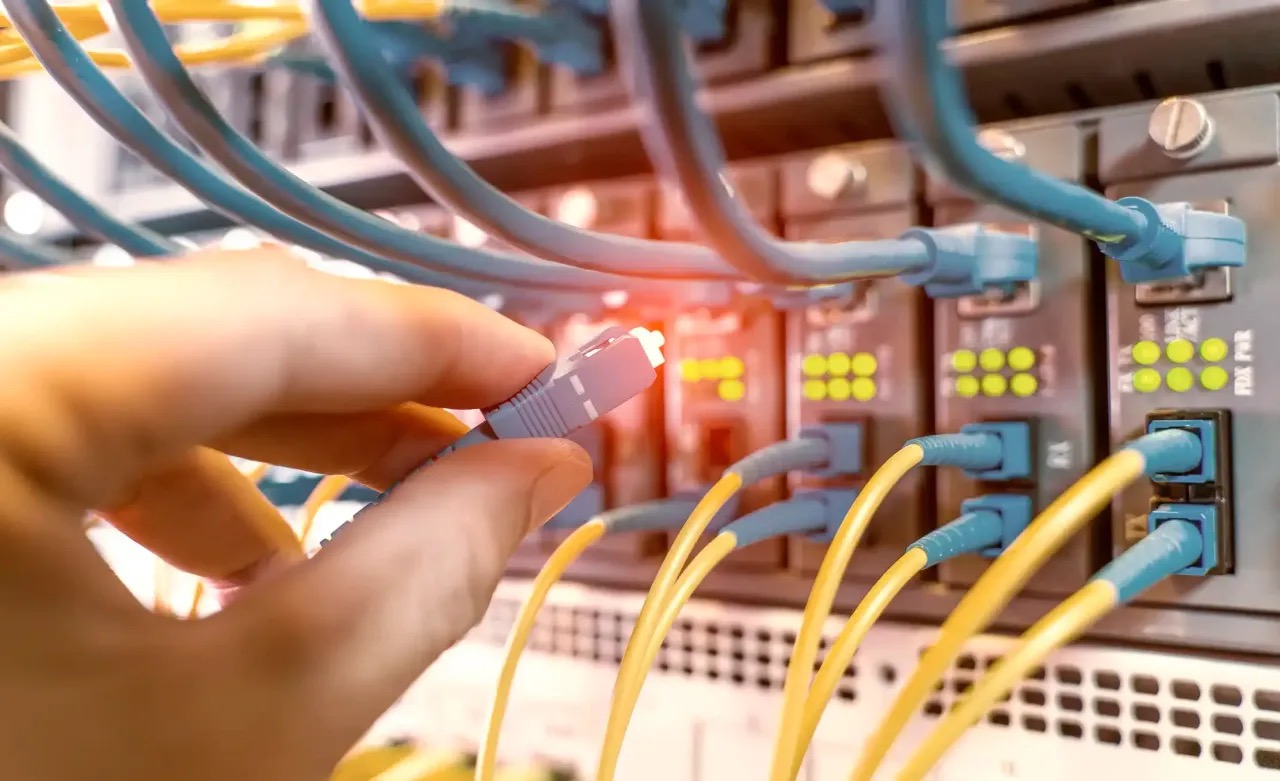 Technician terminating a fiber optic connection