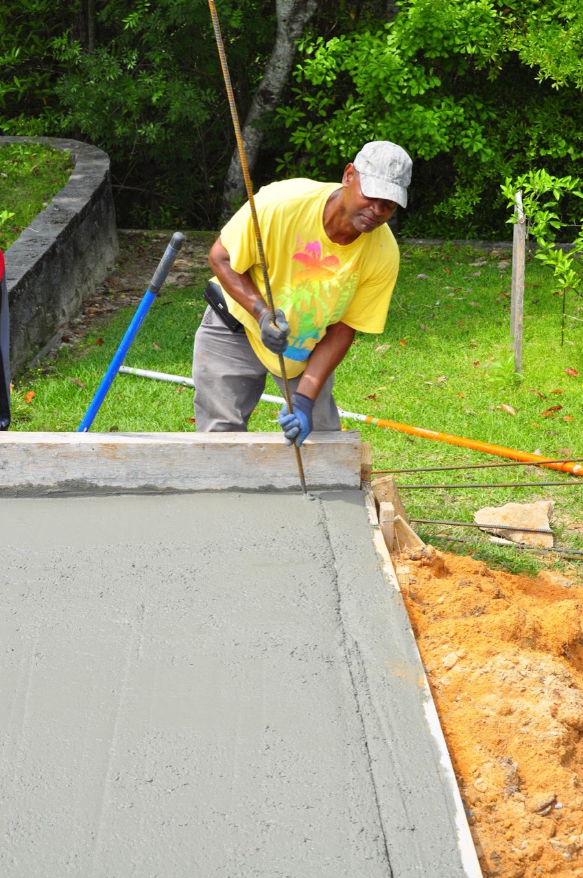 An Xtreme Concrete Company crew member finishing the edge of a fresh pour